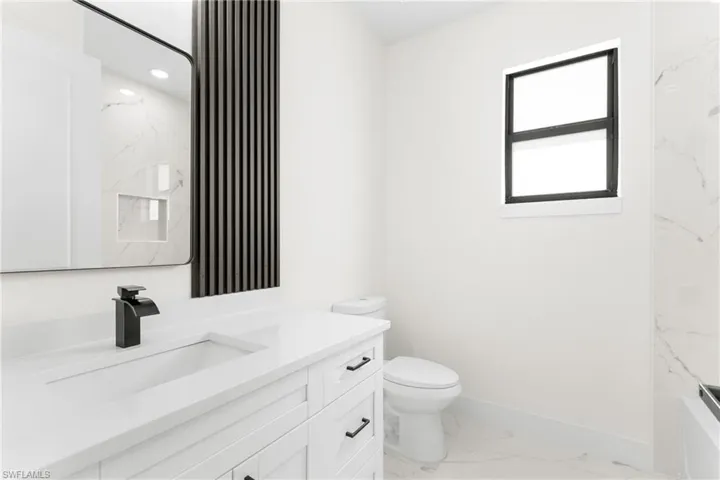 Full bathroom with vanity and light marble finish flooring