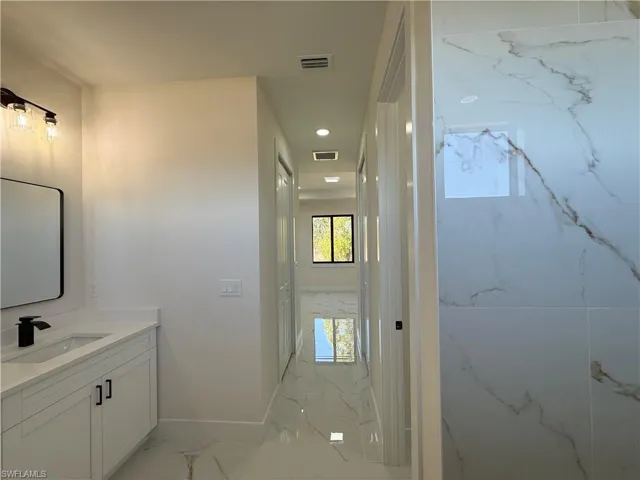 Bathroom with vanity and recessed lighting