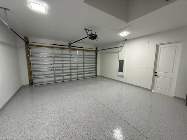 Garage with electric panel and a garage door opener