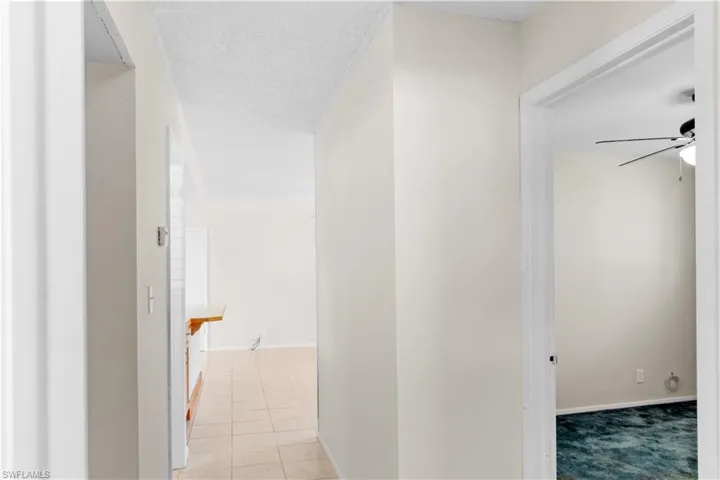 Hallway with 3 bedrooms off of it