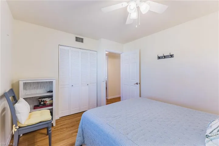 Bedroom with a closet, wood finished floors, and ceiling fan