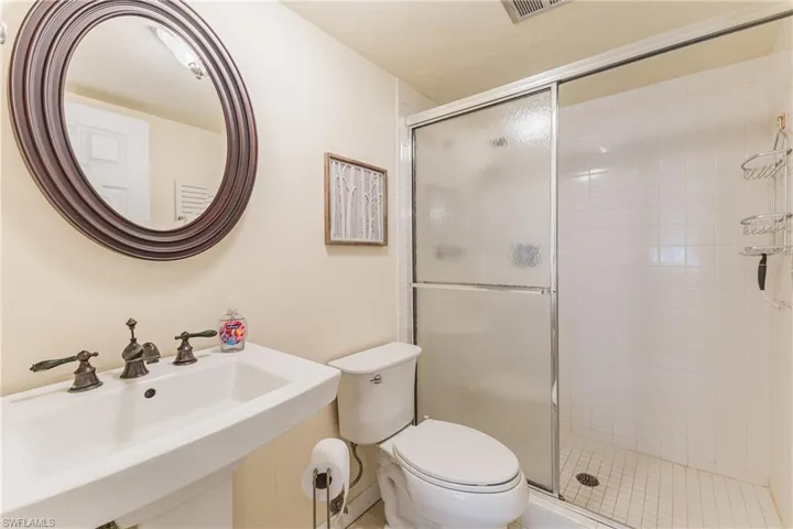 Bathroom featuring toilet and a stall shower
