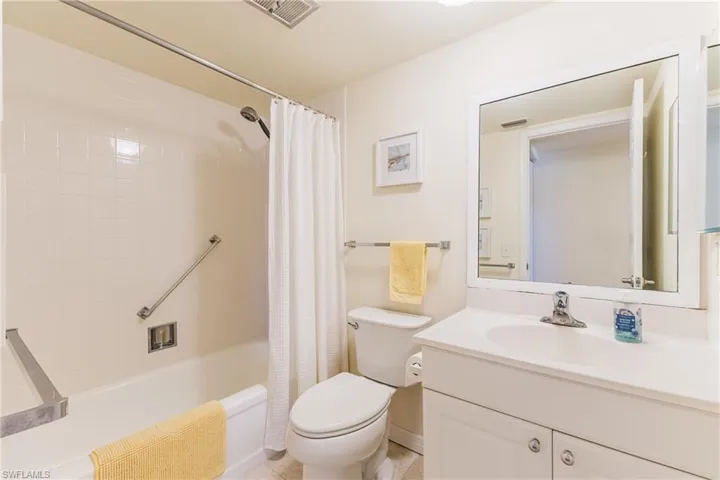 Full bathroom featuring vanity and shower / bathtub combination with curtain
