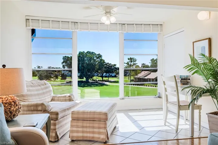 Sunroom featuring golf course view and tile patterned floors