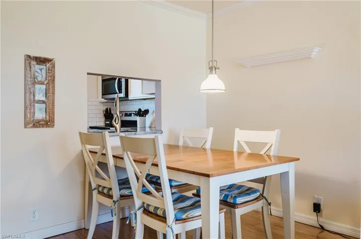 Dining room featuring light wood-style floors and crown molding