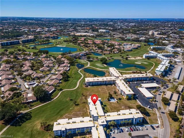 Drone / aerial view of a large body of water and a local golf course
