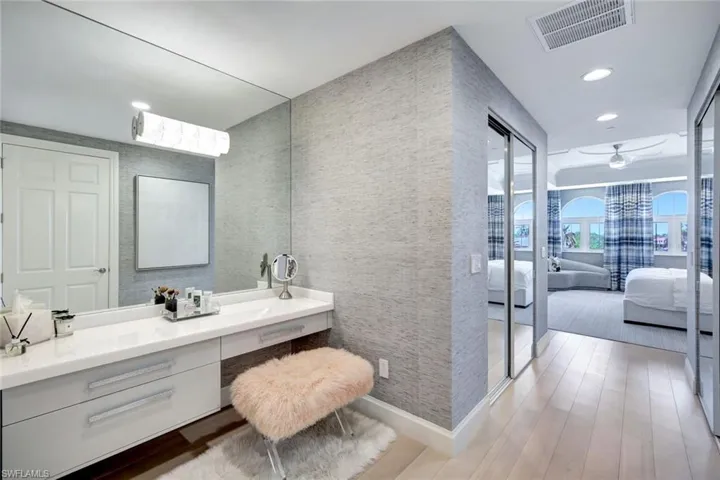Bathroom featuring ceiling fan, vanity, and wood-type flooring