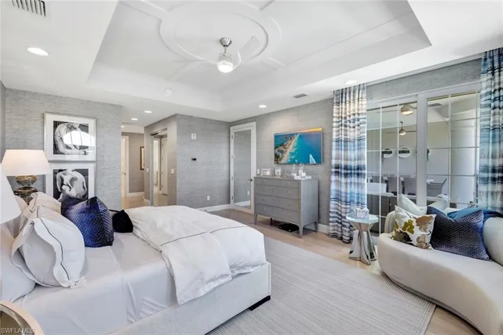 Bedroom featuring a raised ceiling and hardwood / wood-style flooring