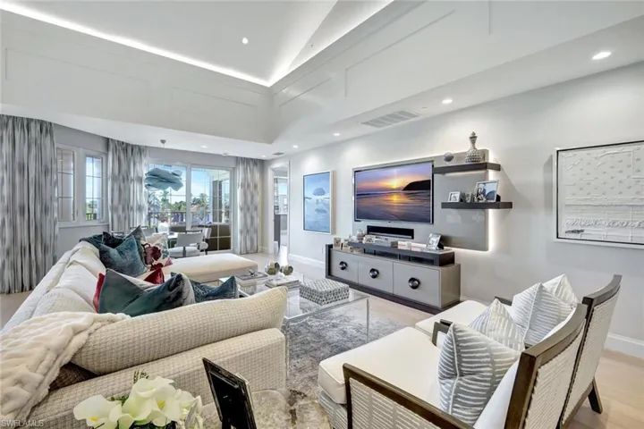 Living room with light hardwood / wood-style flooring and vaulted ceiling