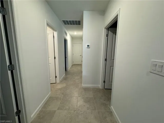 Hallway featuring baseboards