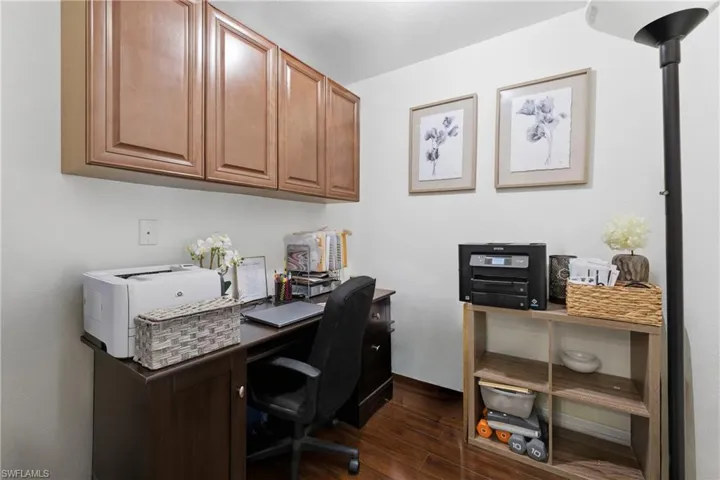Office space featuring dark wood-style flooring