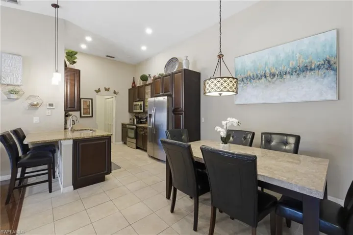Dining area featuring light tile patterned floors and recessed lighting