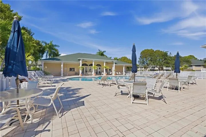Community pool featuring a patio area and outdoor dining space