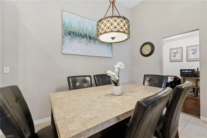 Dining area with light tile patterned flooring