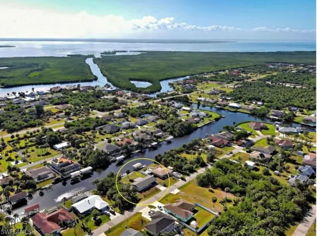 Aerial perspective of suburban area with a nearby body of water