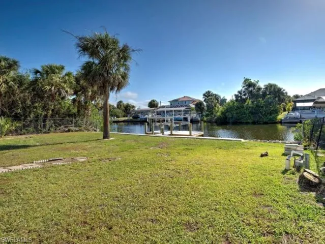 Dock with a water view and a lawn
