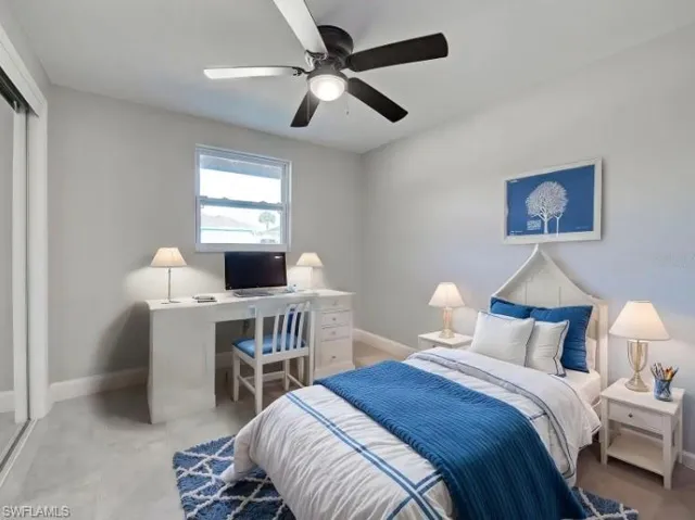 Bedroom with a ceiling fan and an office area