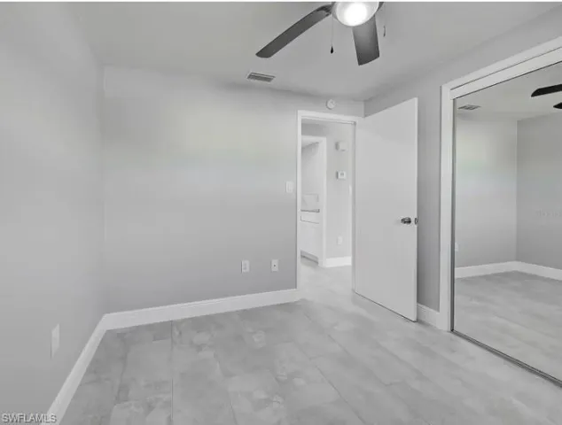 Unfurnished bedroom featuring a ceiling fan and a closet