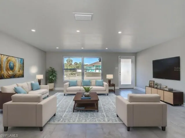 Living area with baseboards and recessed lighting