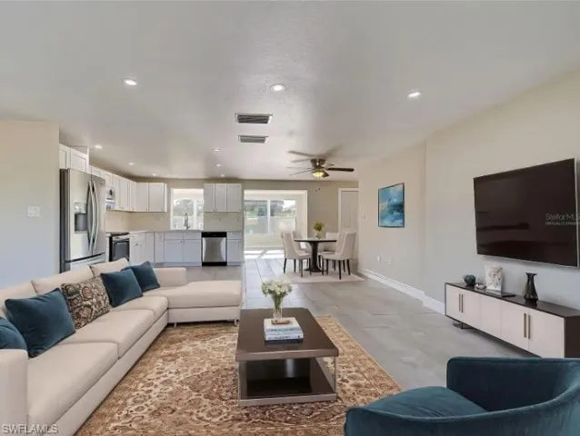 Living room featuring recessed lighting and a ceiling fan