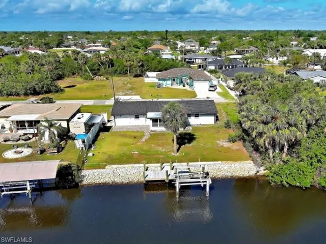 Aerial perspective of suburban area featuring a large body of water