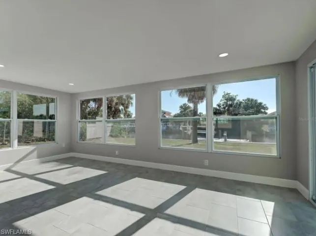 Unfurnished room with light tile patterned floors and recessed lighting