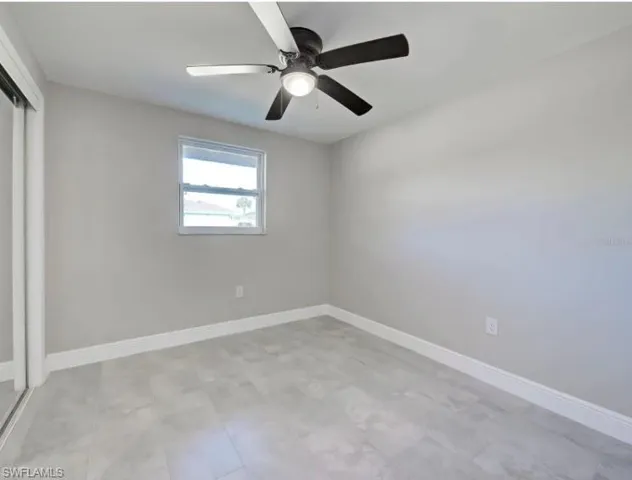 Unfurnished bedroom with a closet and a ceiling fan