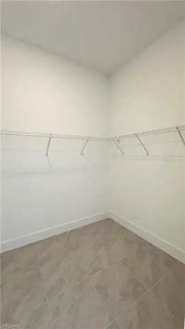 Walk in closet featuring light tile patterned flooring