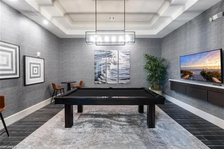 Game room with ornamental molding and pool table
