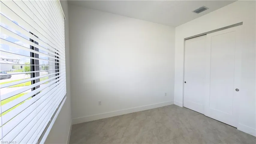 Unfurnished bedroom featuring baseboards and a closet