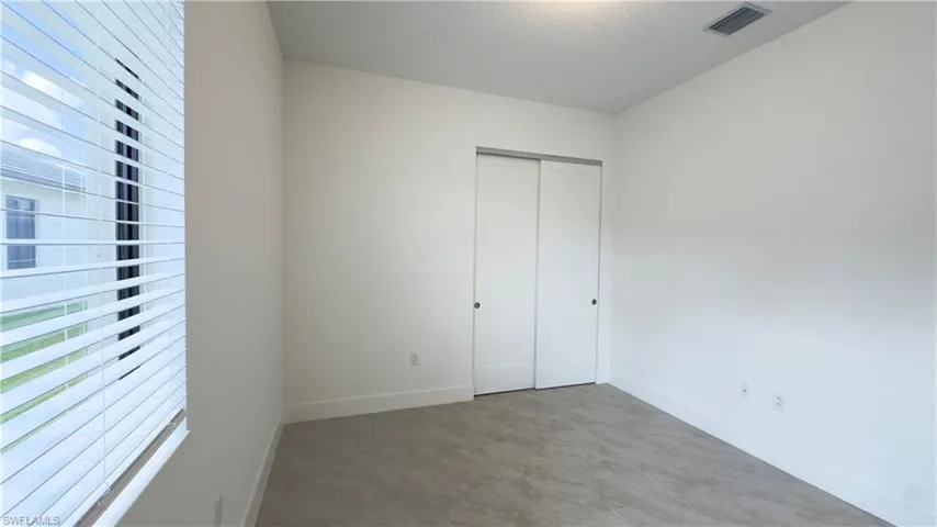 Unfurnished bedroom with baseboards and a closet
