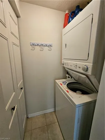 Stackable washer and dryer off of the kitchen