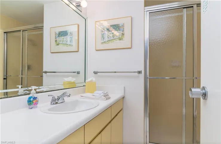 Full bath with vanity and a shower stall