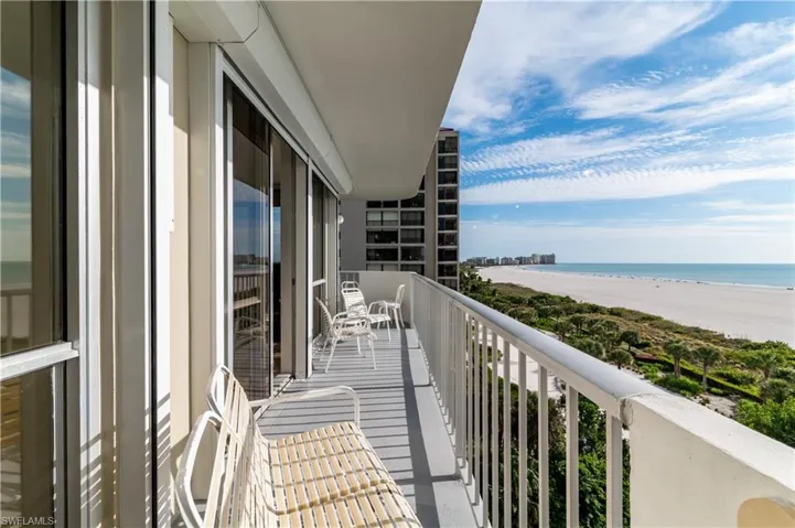 Balcony with view of water and beach