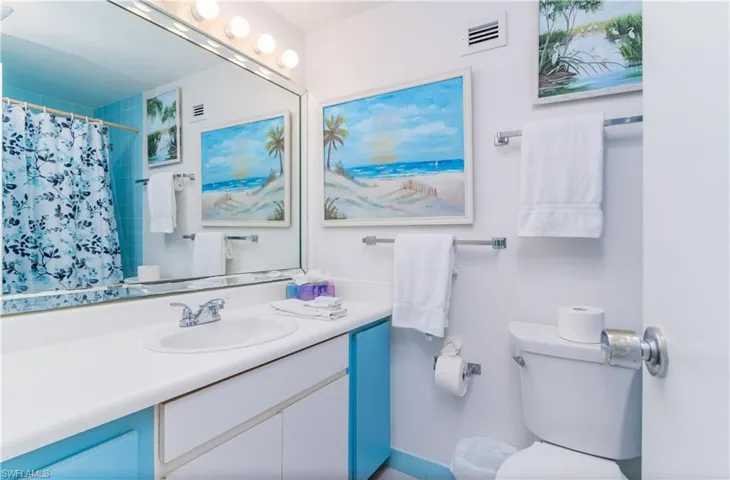 Full bath with vanity and a shower with shower curtain