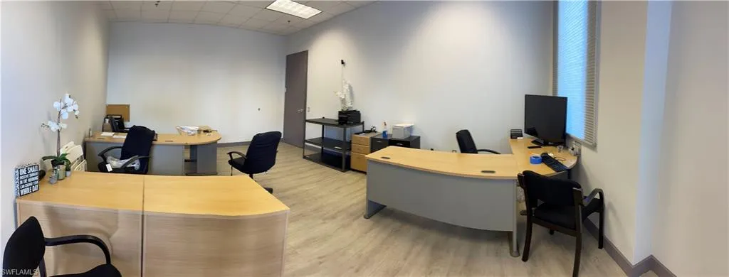 Office space with light hardwood / wood-style flooring