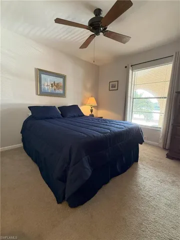 Carpeted 2nd bedroom with ceiling fan