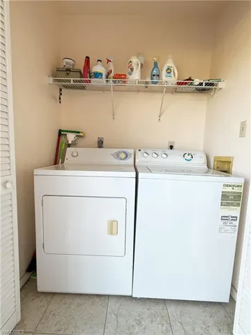 Clothes washing area featuring washer and dryer