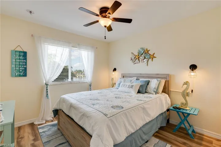 Bedroom with wood finished floors and ceiling fan