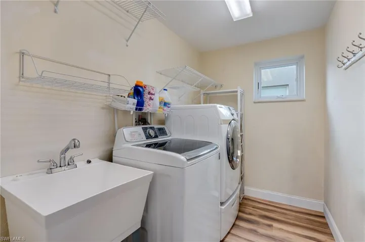 Laundry room featuring separate washer and dryer and light wood finished floors