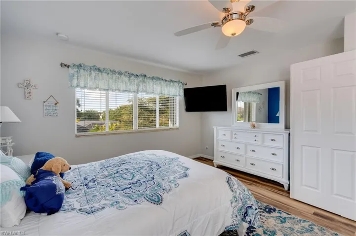 Bedroom with a ceiling fan and light wood-style flooring