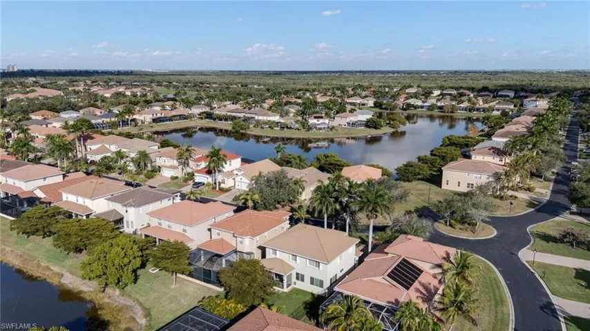 Aerial perspective of suburban area featuring a nearby body of water
