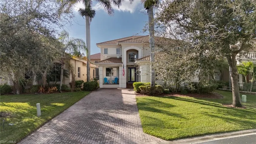 Mediterranean / spanish-style home featuring a front lawn, stucco siding, and a tile roof