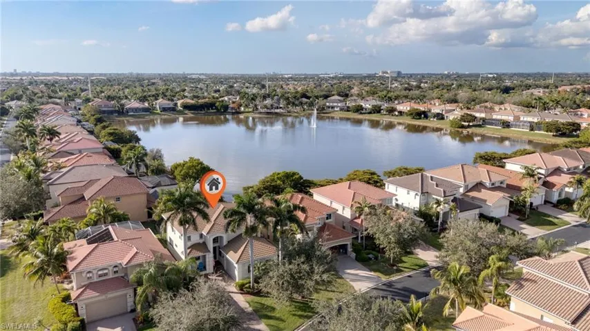 Aerial perspective of suburban area featuring a large body of water