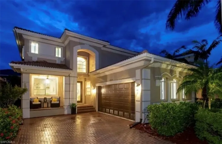 Mediterranean / spanish house with stucco siding, a garage, decorative driveway, and a tiled roof