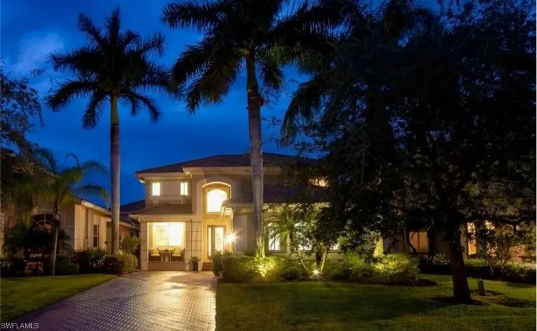 Mediterranean / spanish house with a lawn and stucco siding