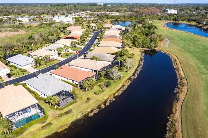 Aerial perspective featuring a waterfront residential parcel with direct access to a canal and proximity to a golf course fairway