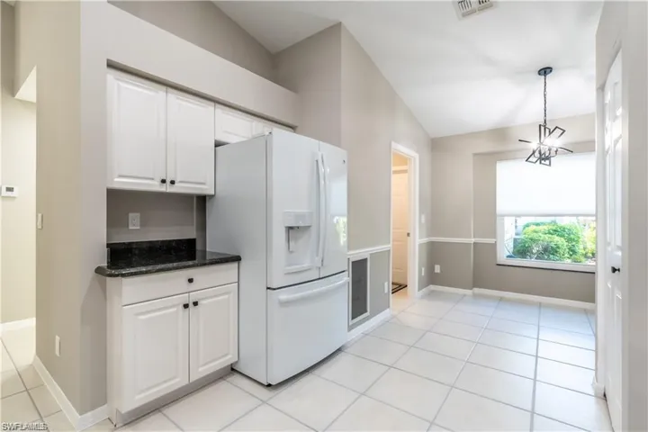 Modern open Kitchen with Dining area and access to Laundry Room and Garage