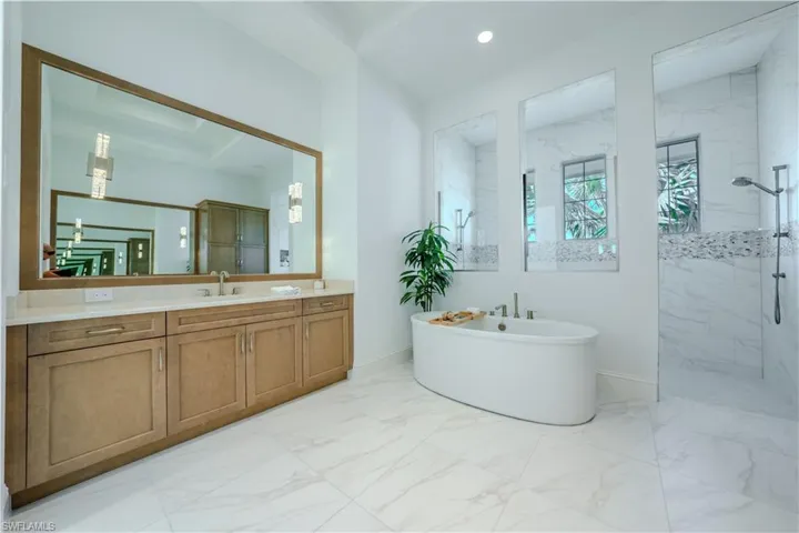 Bathroom with vanity and separate shower and tub