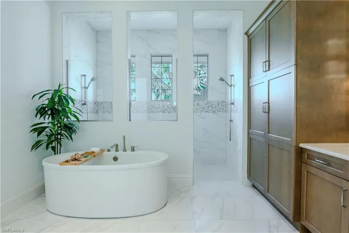 Bathroom featuring vanity and independent shower and bath